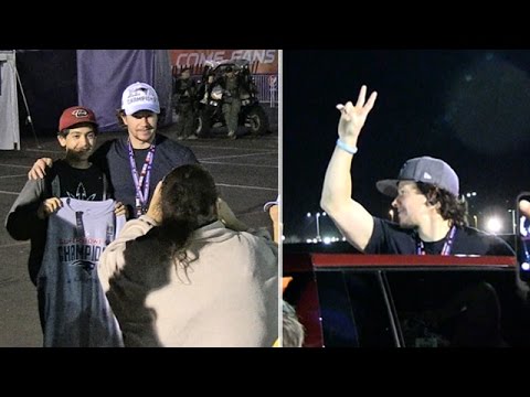 Mark Wahlberg gives a fan his Super Bowl hat after the game