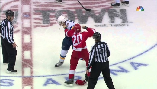 Drew Miller appears to punch the St. Louis Blues logo off the helmet of Lindbohm