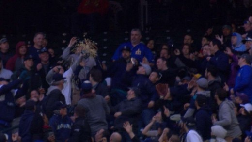 Fan snags a foul ball with bucket of popcorn