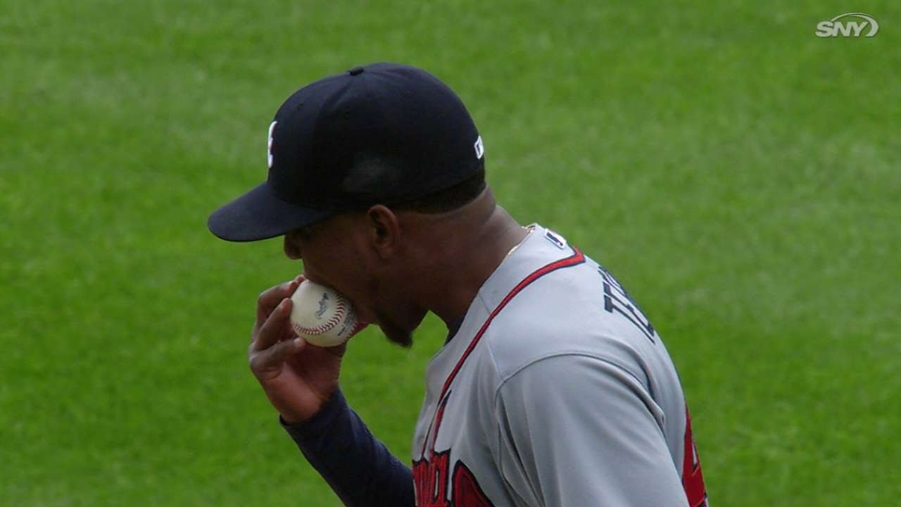 Julio Teheran bites baseball after walk to Cuddyer