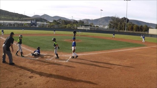 Youth baseball player impressively hurdles catcher