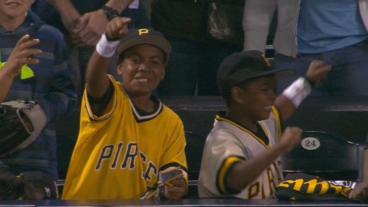 Andrew McCutchen gives his batting gloves to two young Pirates fans