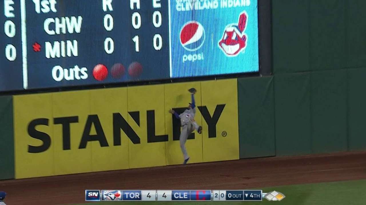 Kevin Pillar makes a leaping catch at the wall