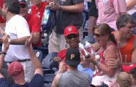 Fan catches a foul ball with two beers in her hands