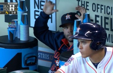 Jose Altuve keeps busy in the dugout as he stacks drinking cups