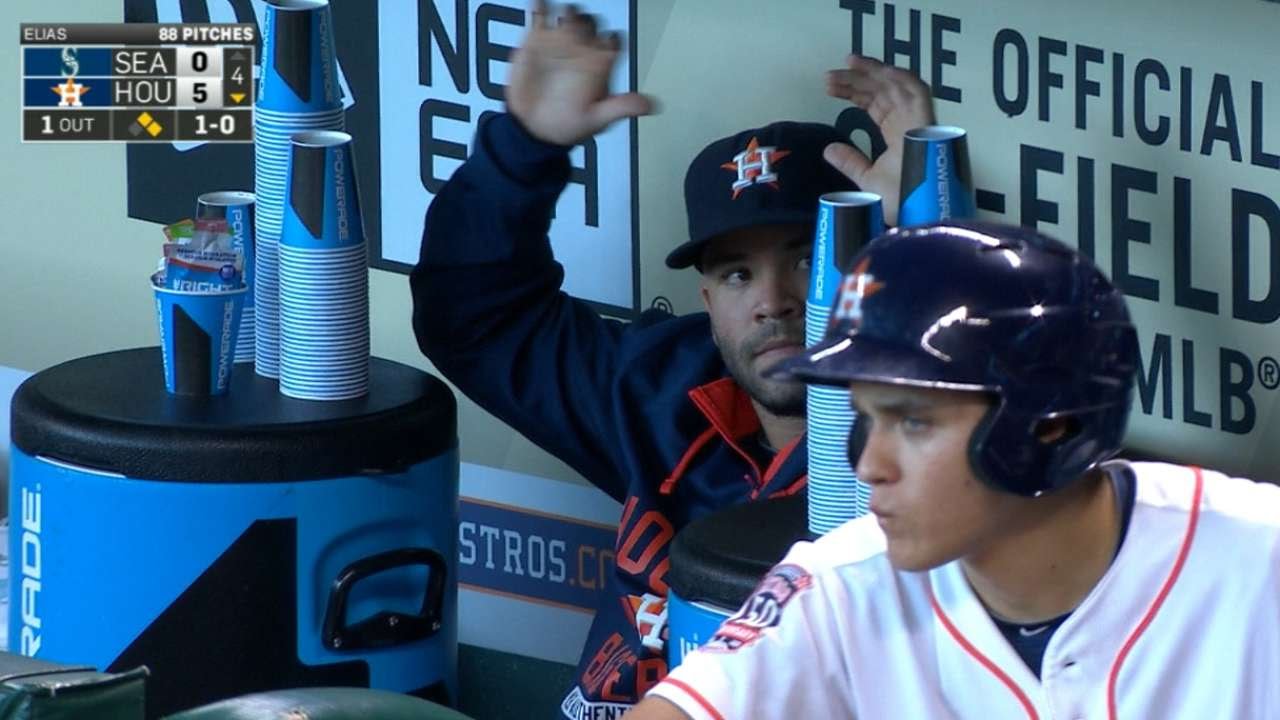 Jose Altuve keeps busy in the dugout as he stacks drinking cups