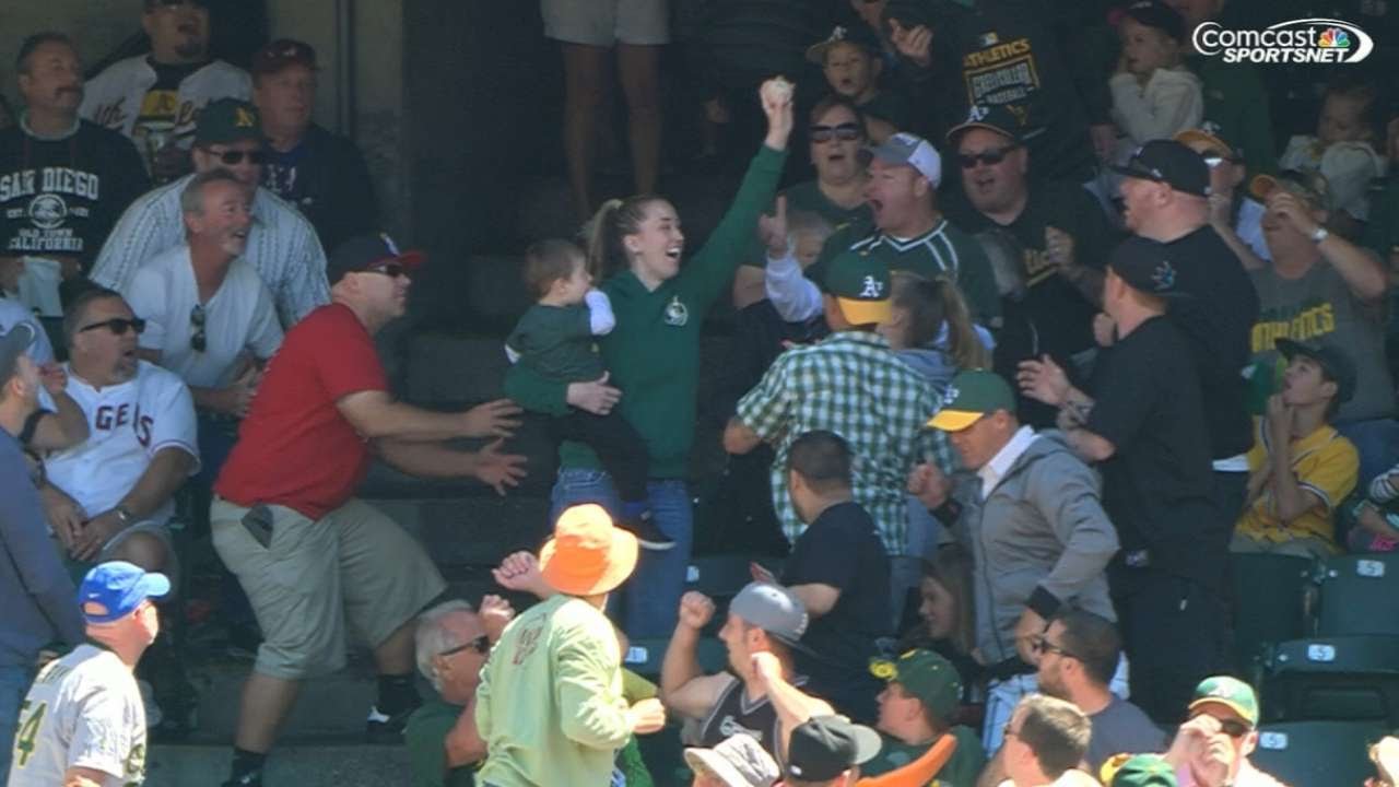Oakland A's fan catches foul ball while holding child