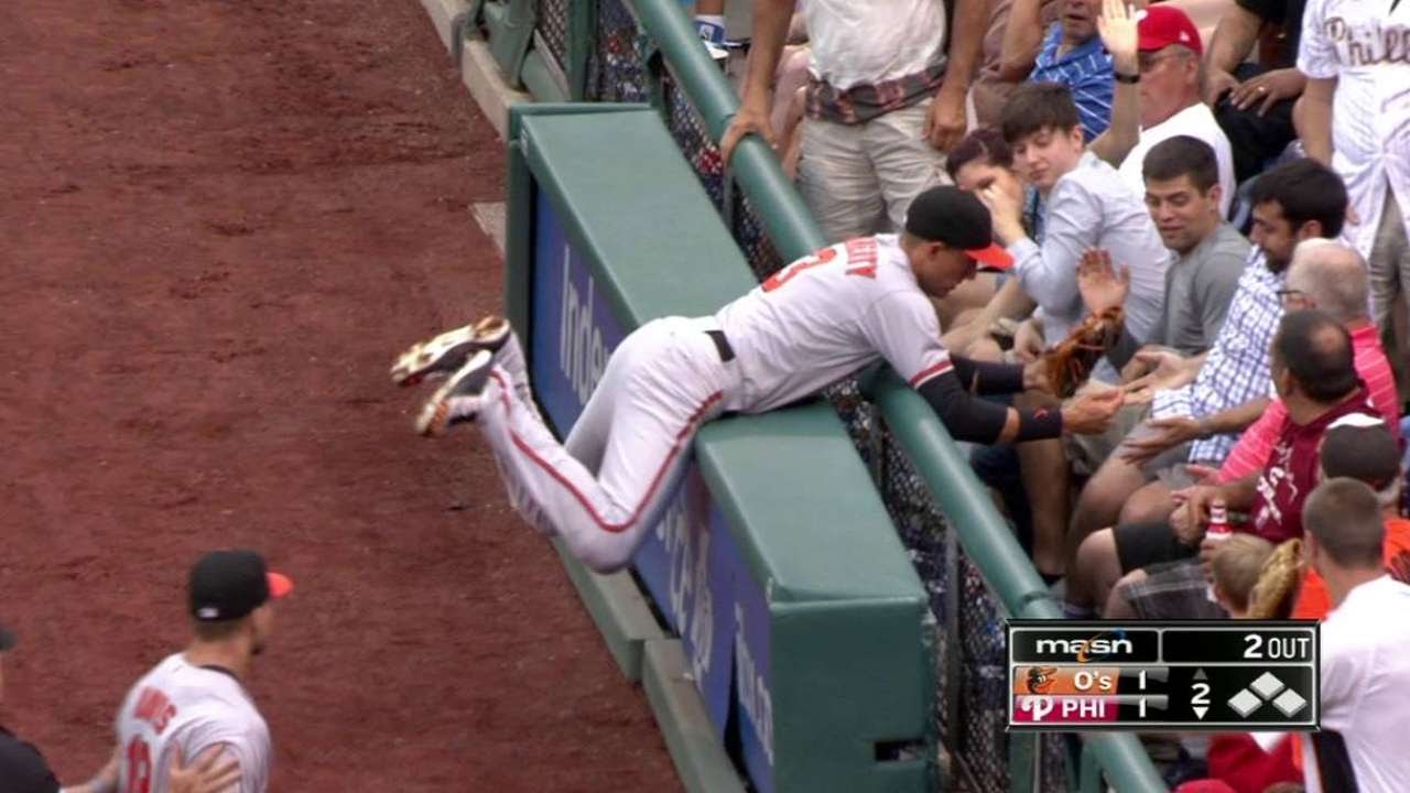 Ryan Flaherty smashes into the wall & reaches over railing to make catch