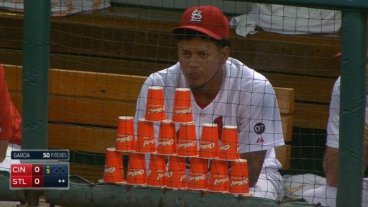 Carlos Martinez protects his cup pyramid from Wacha