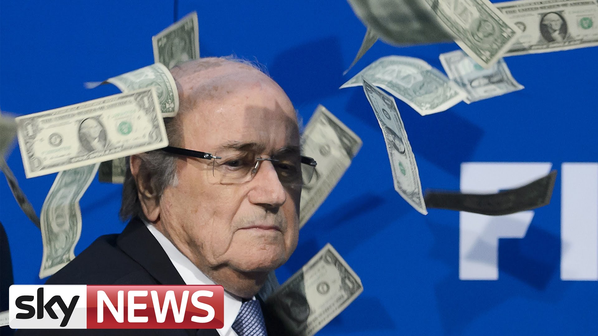 FIFA President Sepp Blatter has money thrown at him by Simon Brodkin