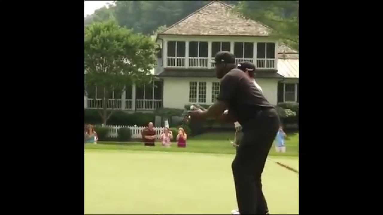 Shaquille O'Neal shoots a golf ball like a free throw into the hole