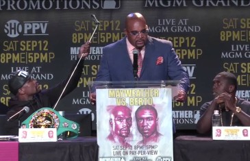Floyd Mayweather takes a selfie on a selfie stick during press conference