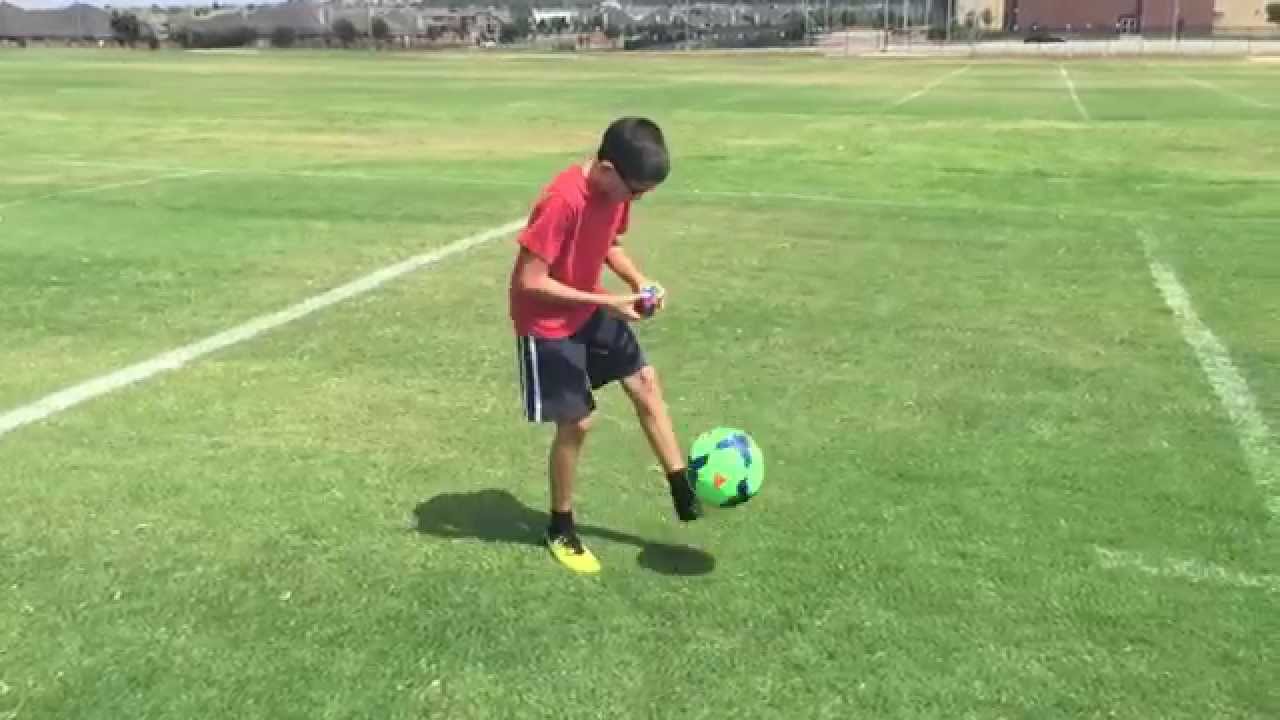 11 year old solves a rubik's cube while doing keep ups with a soccer ball