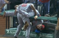 Reds 3B Todd Frazier gets put in an awkward position after making railing catch