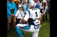 Cam Newton ‘supermans’ with a young fan before game