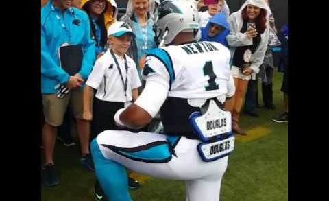 Cam Newton ‘supermans’ with a young fan before game