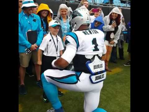 Cam Newton 'supermans' with a young fan before game
