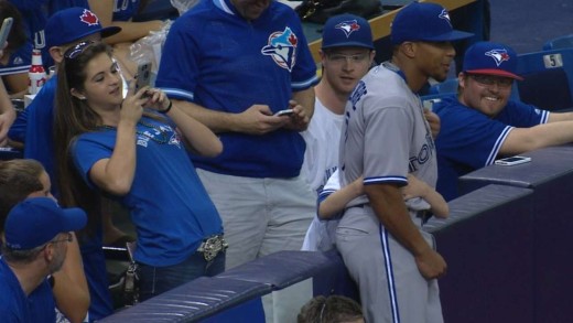 Ben Revere takes photo with young Blue Jays fan in the stands