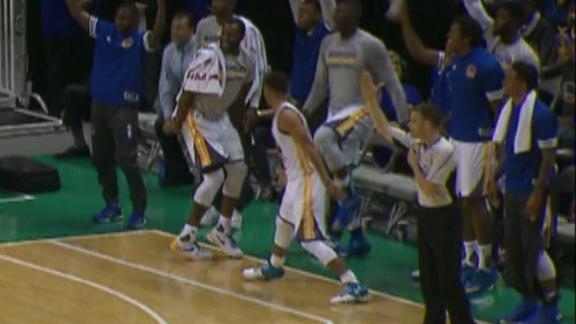 Steph Curry high fives a teammate before the shot even goes in