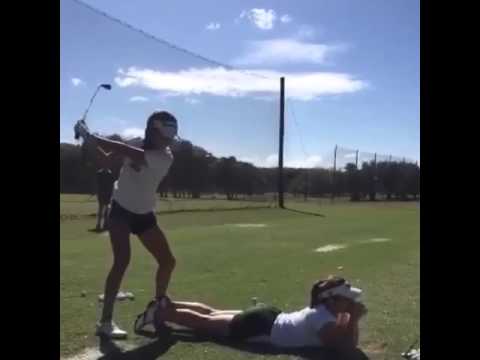 Golfer Mari Rodriguez uses teammates butt as a tee