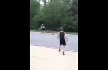 Kid throws basketball at young lady riding a bicycle