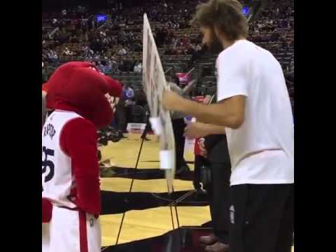Robin Lopez drills the Raptors mascot with a sign