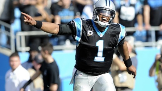 Too Cute: Cam Newton takes throwing advice from a young kid