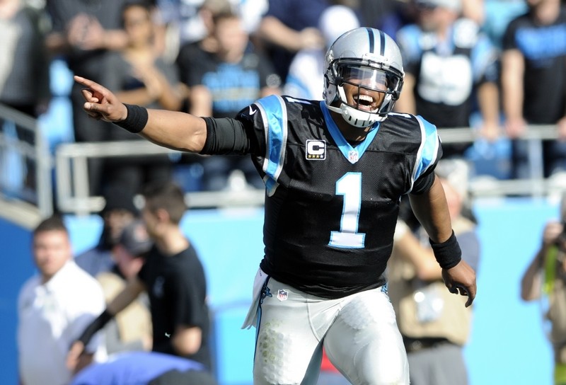 Too Cute: Cam Newton takes throwing advice from a young kid