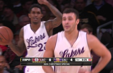 Lakers player Larry Nance tips the ball into his own basket