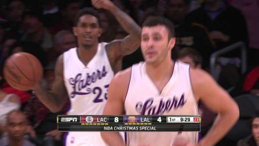 Lakers player Larry Nance tips the ball into his own basket