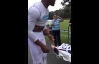 Cam Newton signs his cleats for fan in a wheelchair (Throwback)
