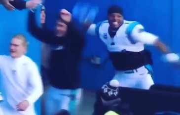 Cam Newton throws a Seattle Seahawks ’12th Man” flag