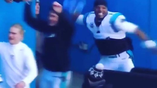 Cam Newton throws a Seattle Seahawks ’12th Man” flag