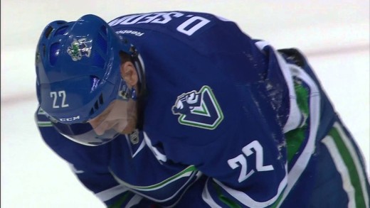 Canucks’ Daniel Sedin takes a puck right in the mouth