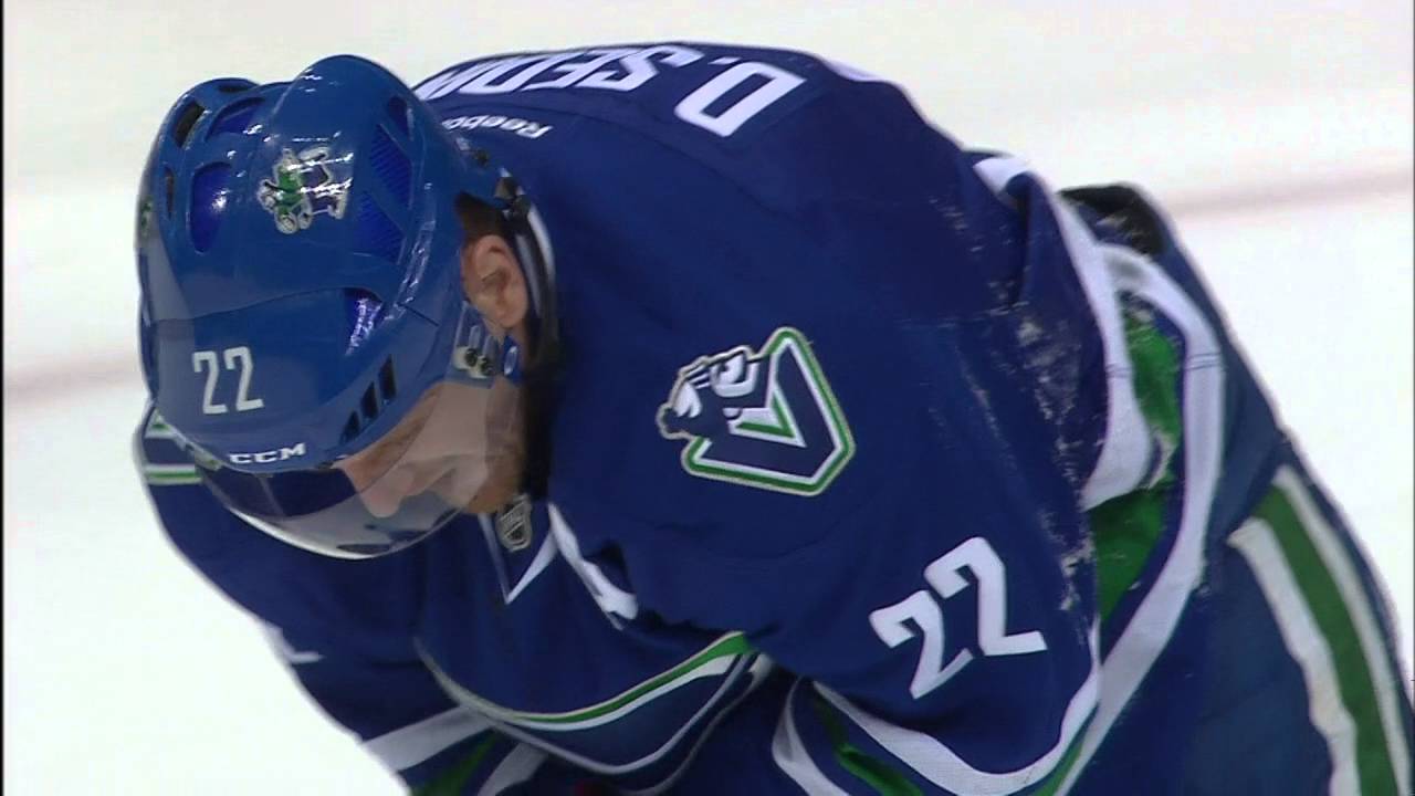 Canucks' Daniel Sedin takes a puck right in the mouth