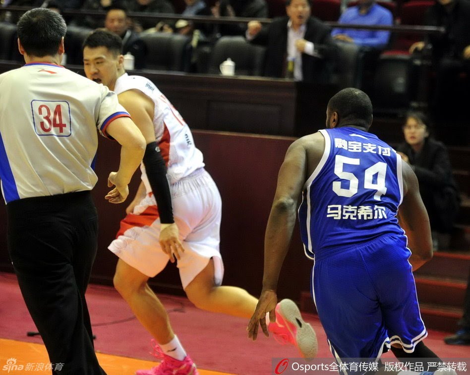 Former NBA player Jason Maxiell chases down a Chinese player to fight him