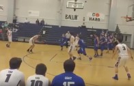 High School basketball player scores on a header tip in