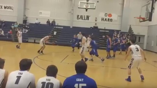 High School basketball player scores on a header tip in