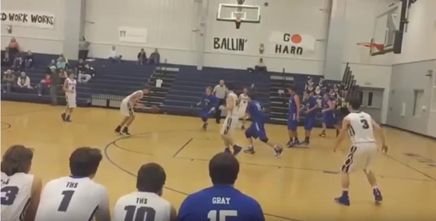 High School basketball player scores on a header tip in