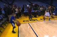 Steph Curry does his pre-game dribbling ritual with a young fan