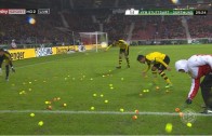 Dortmund fans throw hundreds of tennis balls onto pitch