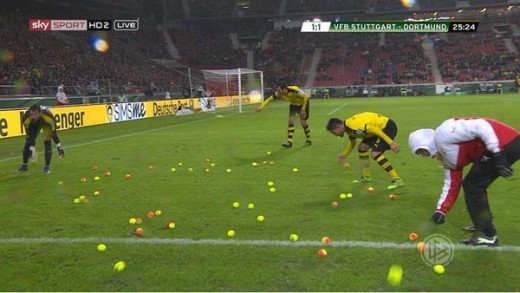 Dortmund fans throw hundreds of tennis balls onto pitch