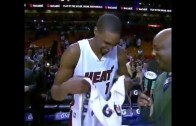 Chris Bosh covers camera with his towel after interview