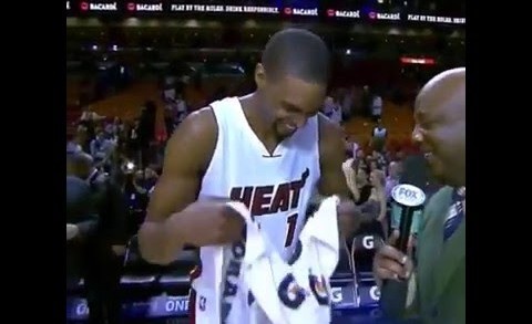 Chris Bosh covers camera with his towel after interview