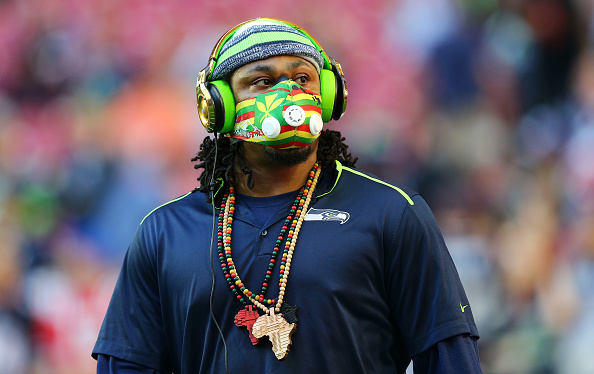 Marshawn Lynch steals a fans hat who was asking for an autograph