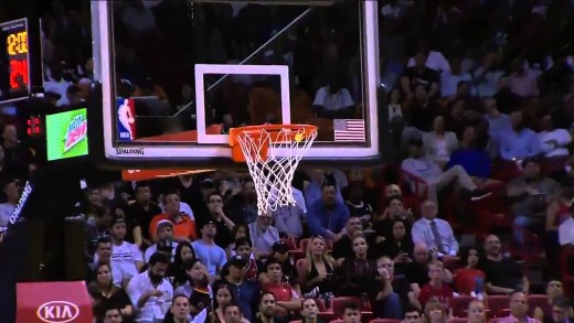 Golfer Matt Kuchar hits a golf ball into hoop from half court