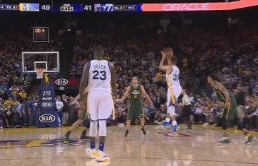 Stephen Curry banks in half court shot