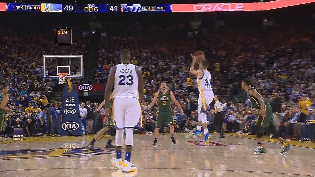 Stephen Curry banks in half court shot