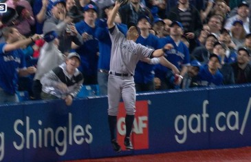 Brett Gardner leaps into the stands to make the catch