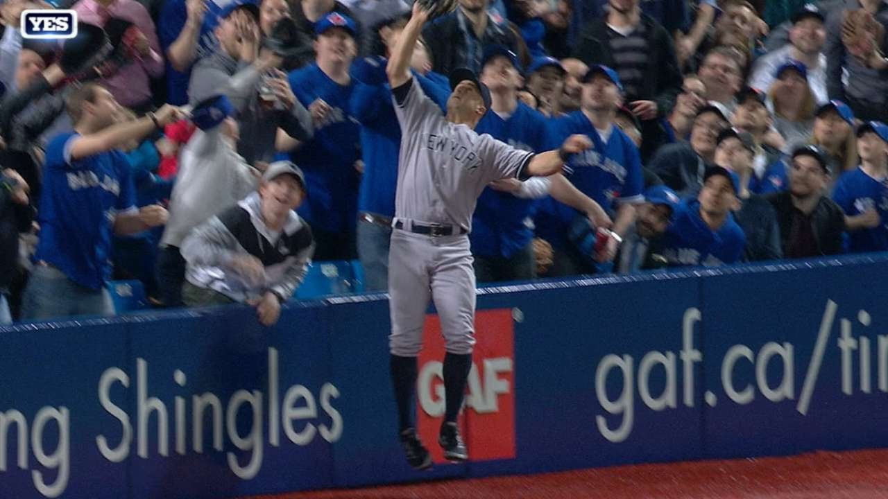 Brett Gardner leaps into the stands to make the catch